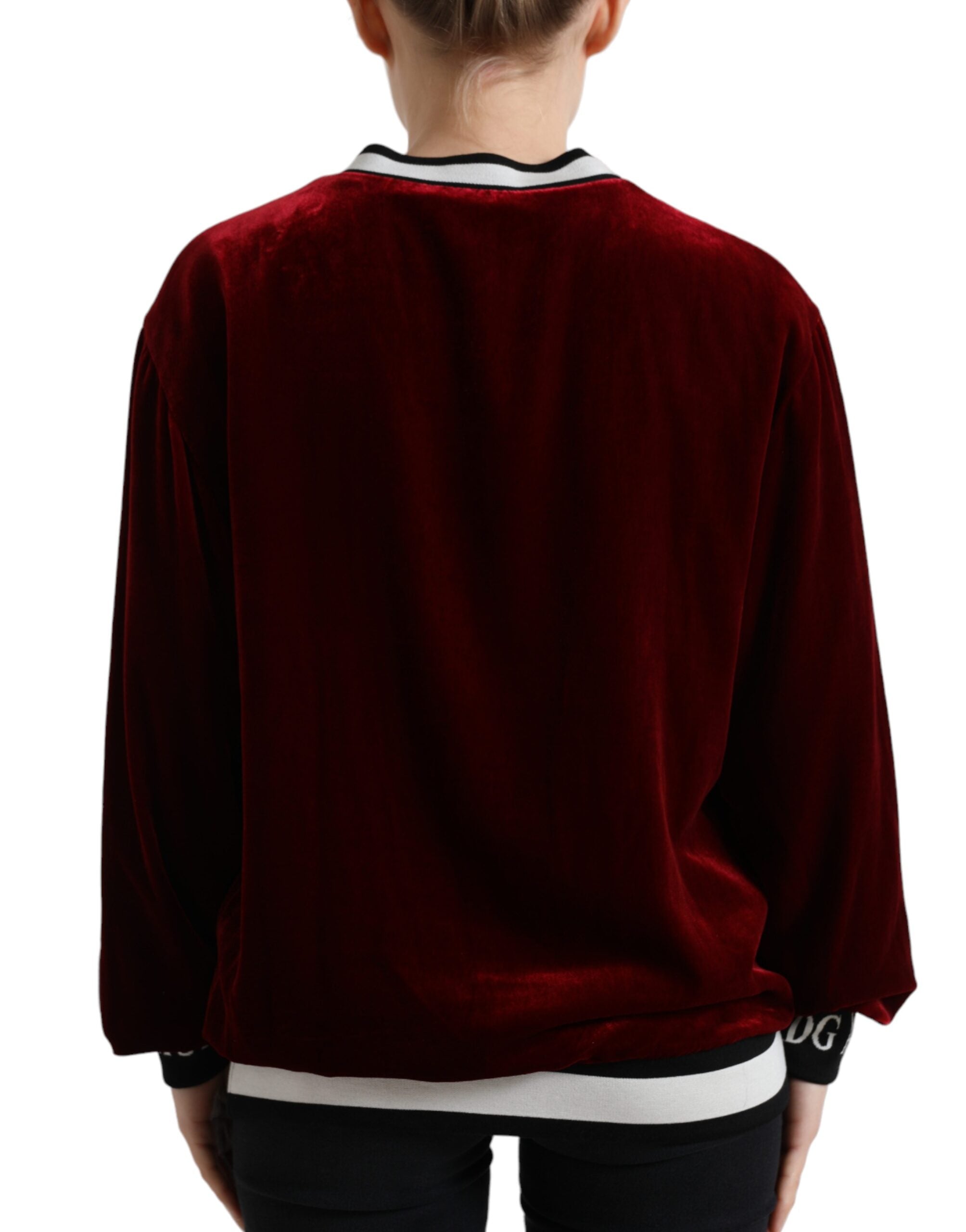 Dolce & Gabbana Bordeaux velvet crew neck pullover sweater displayed on a hanger, showcasing its rich color and soft texture.