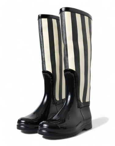 Black rubber knee-high flat boots by Dolce & Gabbana, featuring a sleek design and smooth finish.