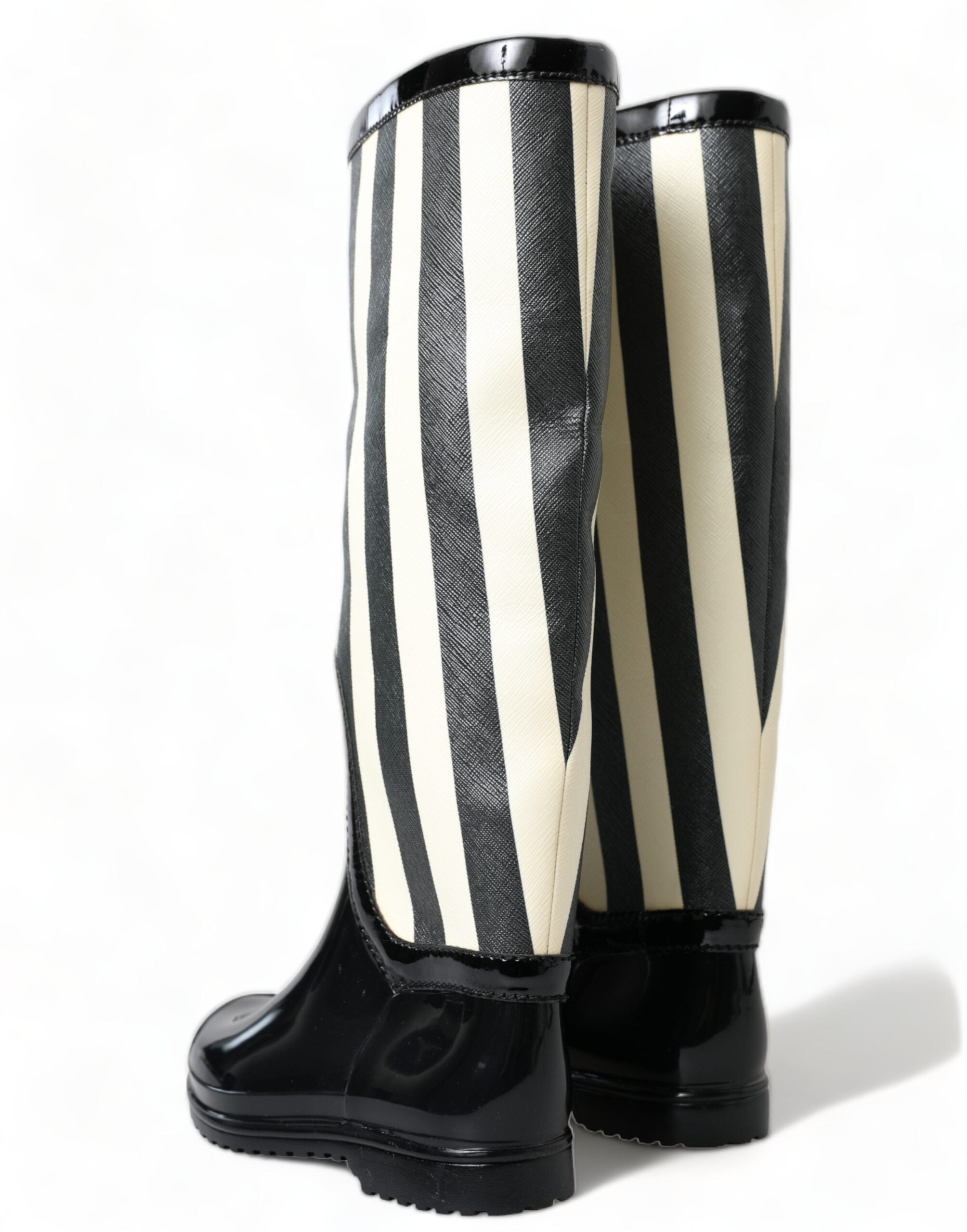 Black rubber knee-high flat boots by Dolce & Gabbana, featuring sleek design and sturdy soles for stylish comfort.