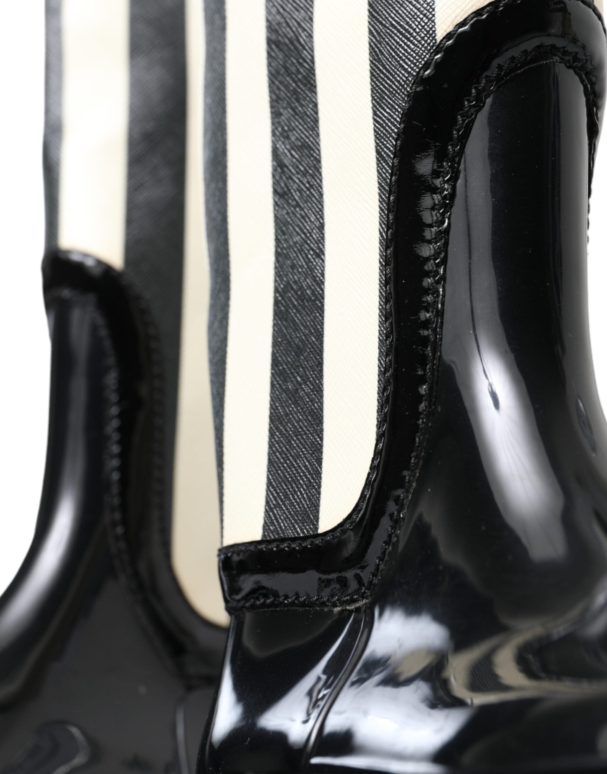 Black rubber knee-high flat boots by Dolce & Gabbana with sleek design and smooth finish, perfect for stylish, comfortable footwear.