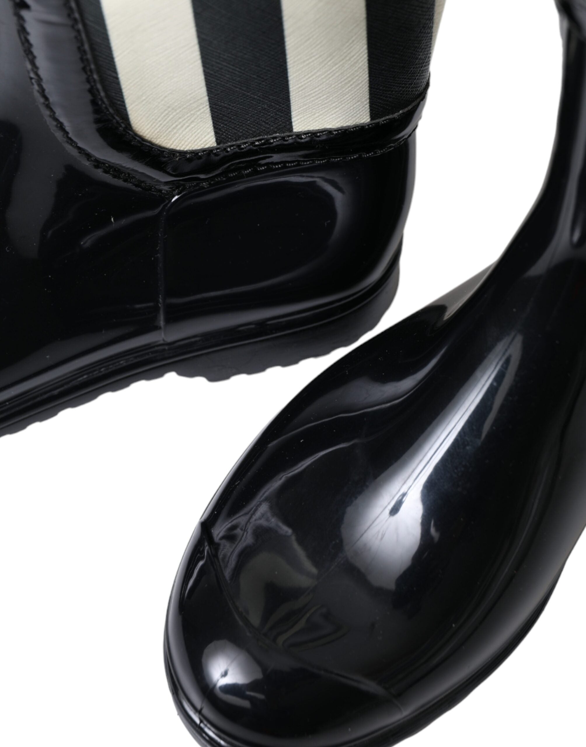 Black rubber knee-high flat boots by Dolce & Gabbana, featuring a sleek design and smooth finish.