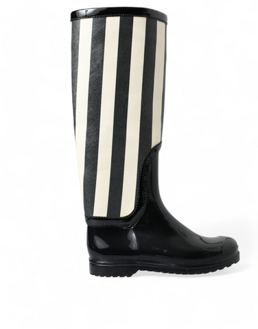Black rubber knee-high flat boots by Dolce & Gabbana, showcasing sleek design and smooth texture, perfect for stylish winter wear.