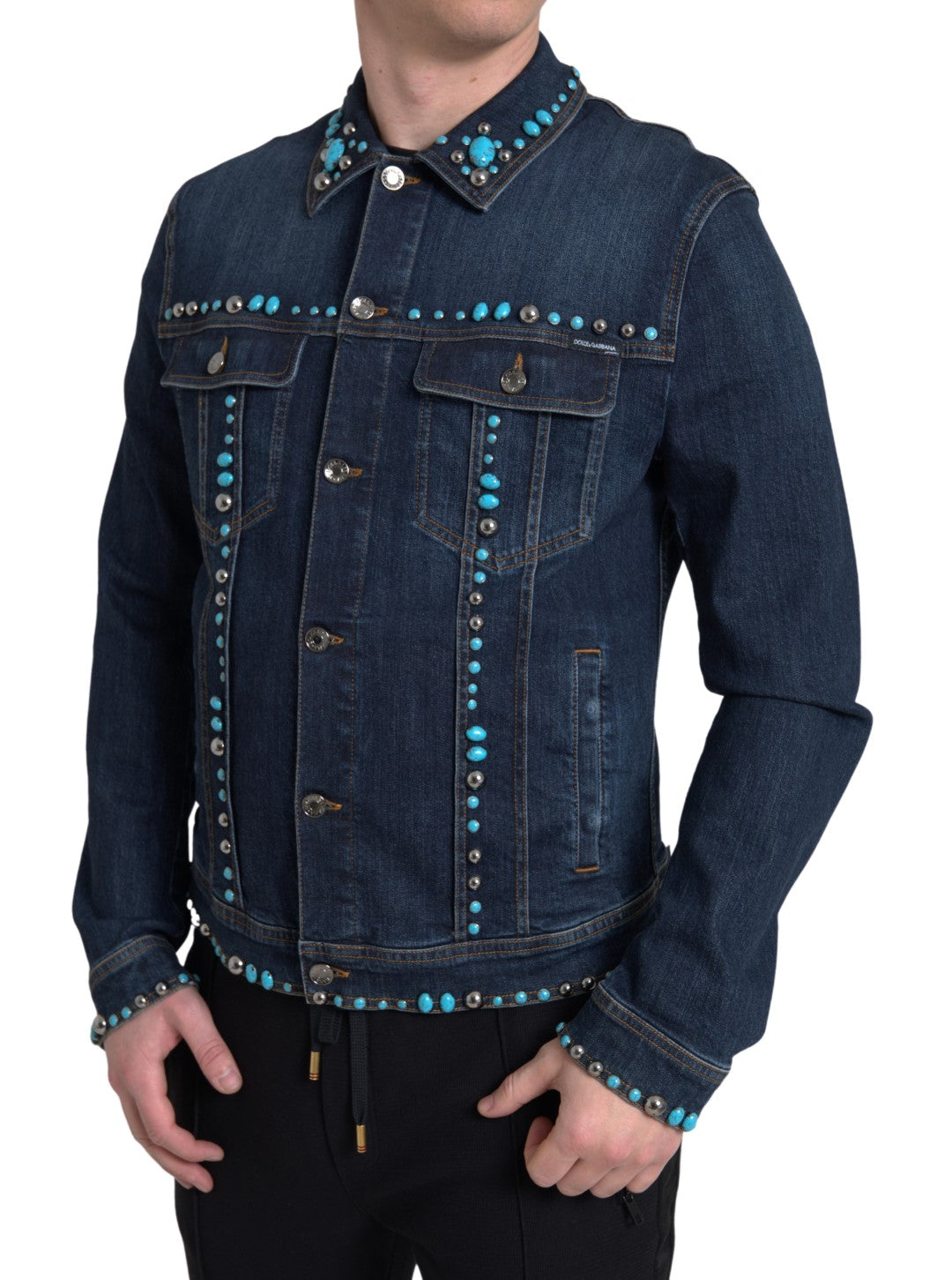 Blue denim jacket with turquoise stones and studded details by Dolce & Gabbana, showcasing a stylish and intricate design.