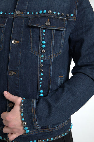 Blue denim Dolce & Gabbana jacket with turquoise stones and studded details, showcasing a stylish, embellished denim outerwear piece.