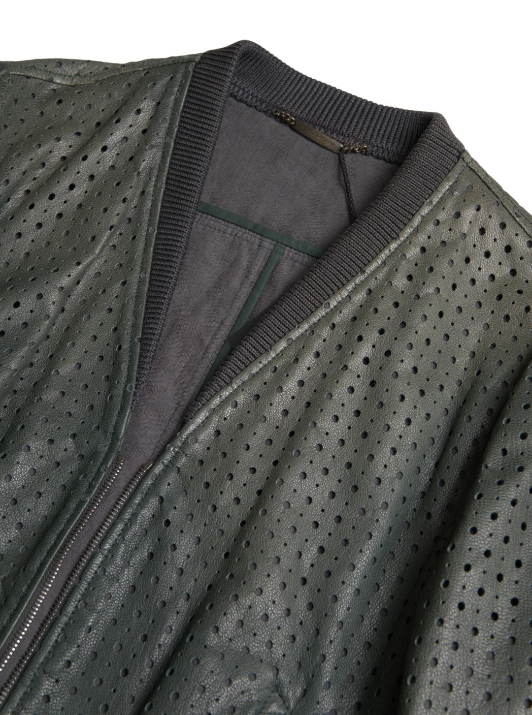 Green perforated leather bomber jacket by Dolce & Gabbana, featuring a stylish, textured design with a front zipper and ribbed cuffs.