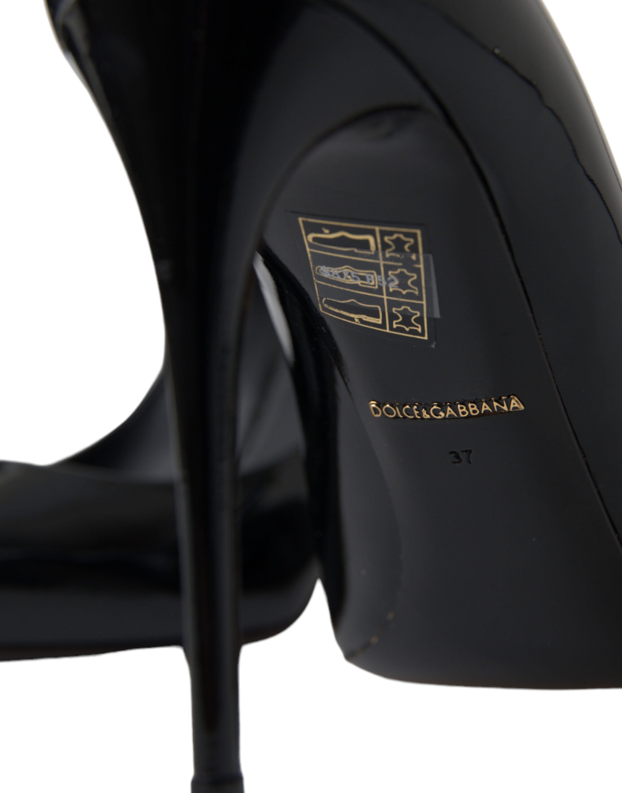 Black patent leather Dolce & Gabbana pumps with high heels and pointed toes, stylish and elegant footwear for women.