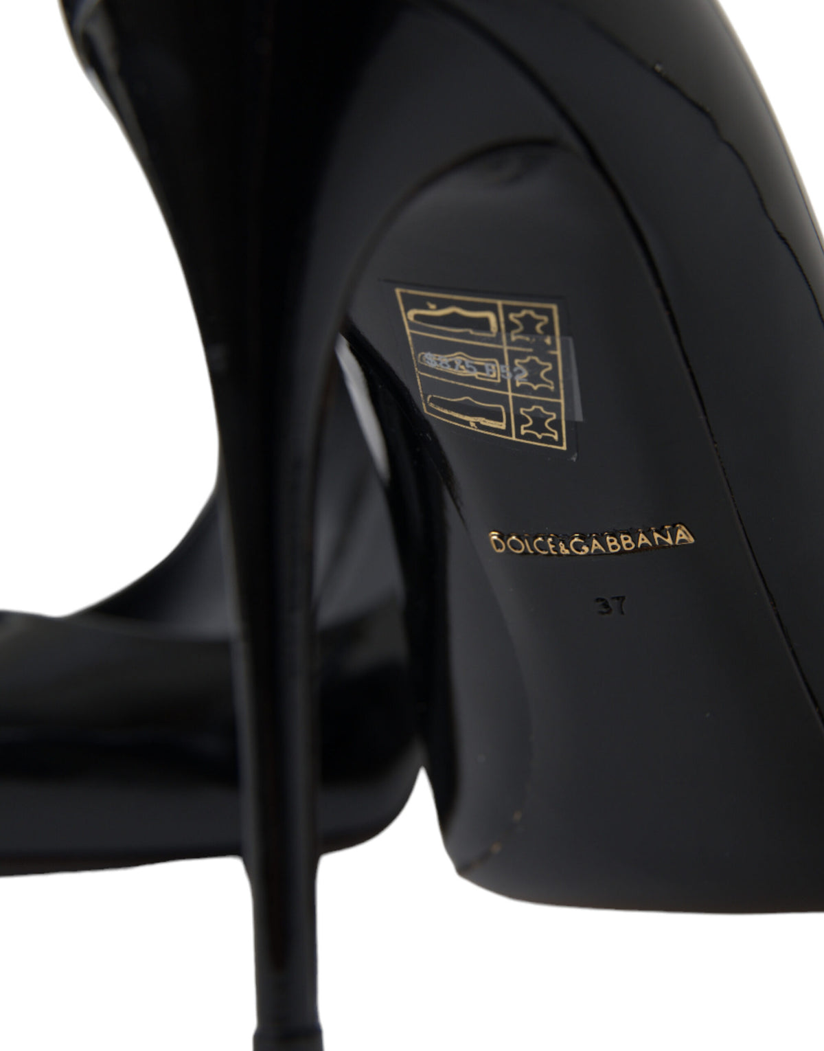 Black patent leather Dolce & Gabbana pumps with high heels and pointed toes, stylish and elegant footwear for women.