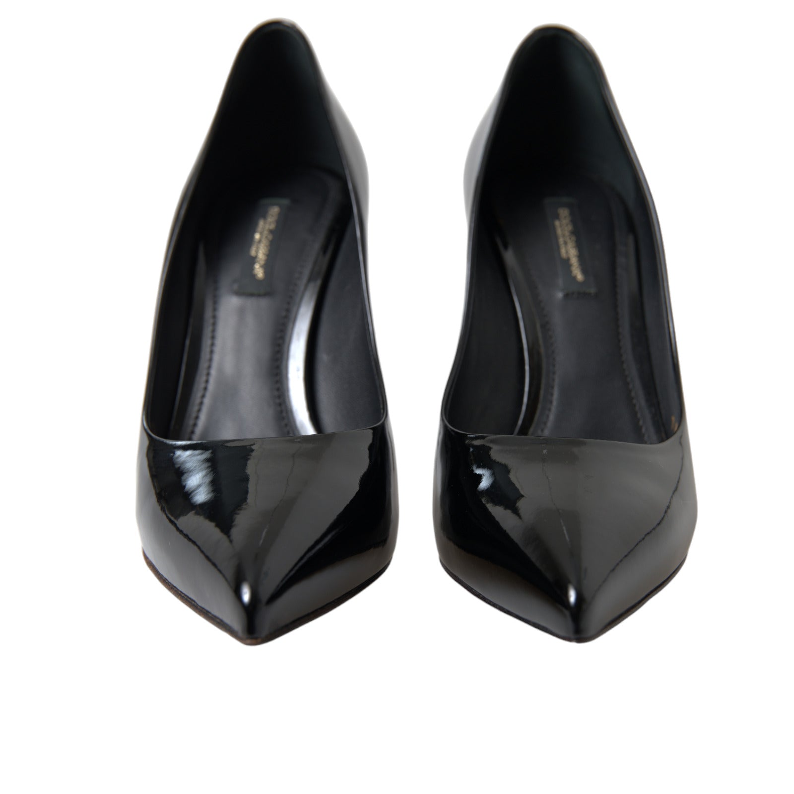 Black patent leather pumps by Dolce & Gabbana featuring pointed toes and stiletto heels.