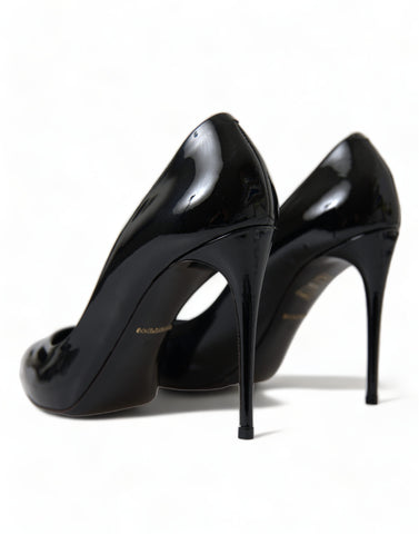 Black patent leather pumps with stiletto heels from Dolce & Gabbana, showcasing elegant pointed toe shoes.