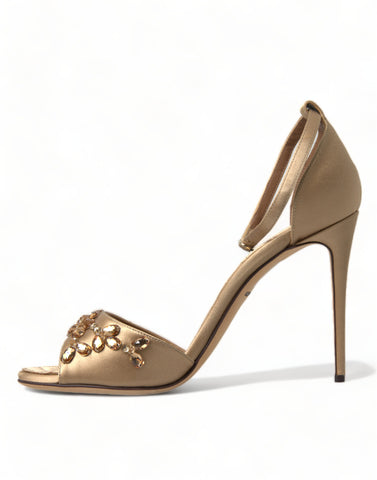Gold satin ankle strap crystal sandals by Dolce & Gabbana with elegant heel and sparkle details.