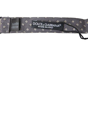Gray silk polka dot bow tie with adjustable neck strap from Dolce & Gabbana, featuring a classic papillon style.
