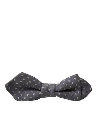 Gray polka dots silk adjustable bow tie with a papillon design by Dolce & Gabbana, shown on a neutral background.