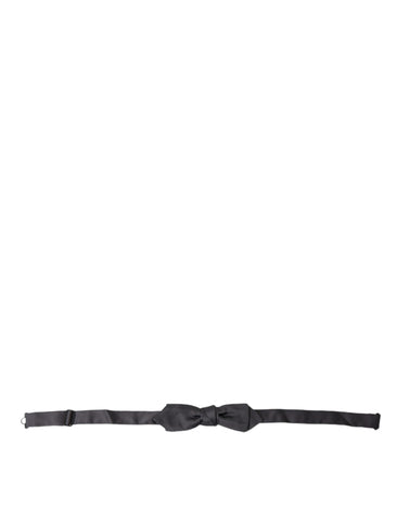 Dark gray silk adjustable men's bow tie with papillon style from Dolce & Gabbana, shown with a classic knot and smooth fabric.
