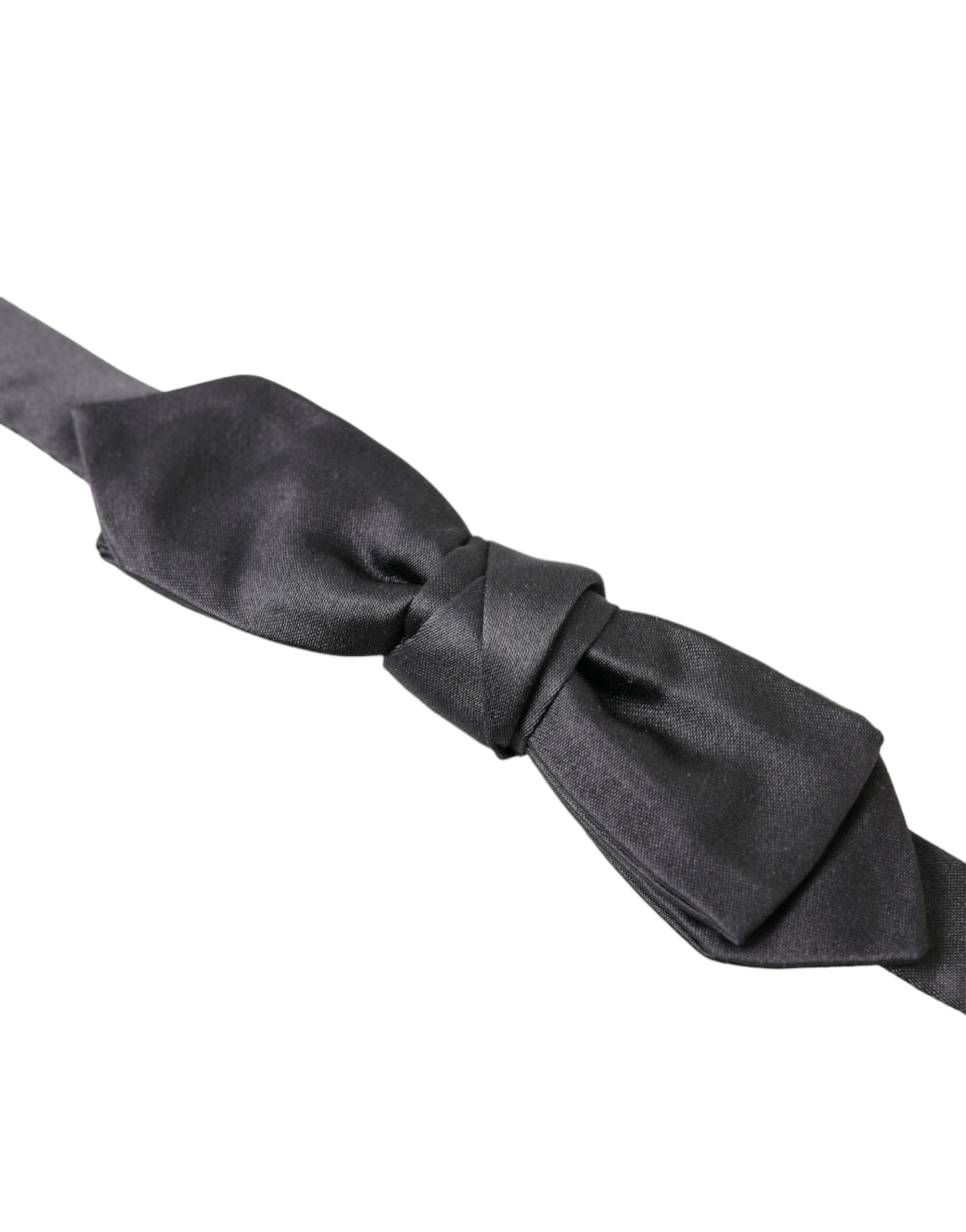 Dark gray silk adjustable men's bow tie featuring a papillon style from Dolce & Gabbana, shown in close-up image.