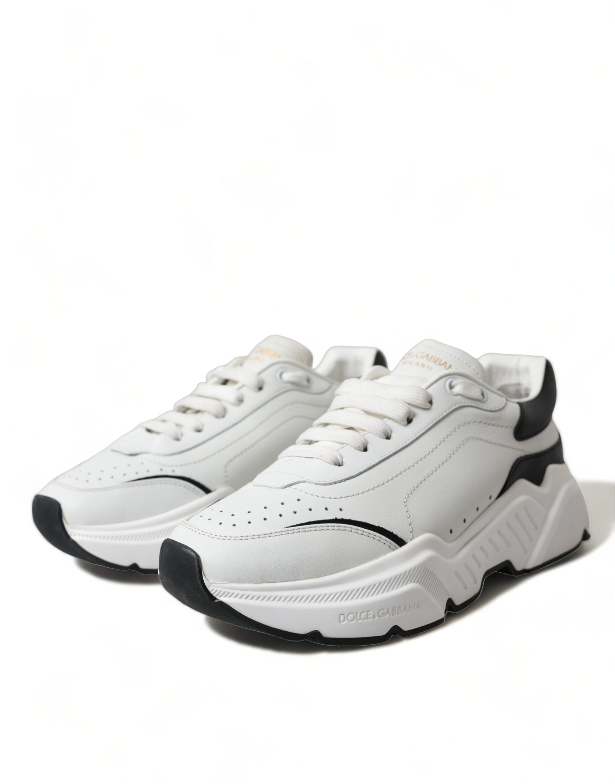 White and black low top Daymaster sneakers by Dolce & Gabbana with sleek design and lace-up closure.