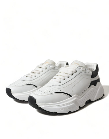White and black low top Daymaster sneakers by Dolce & Gabbana with sleek design and lace-up closure.