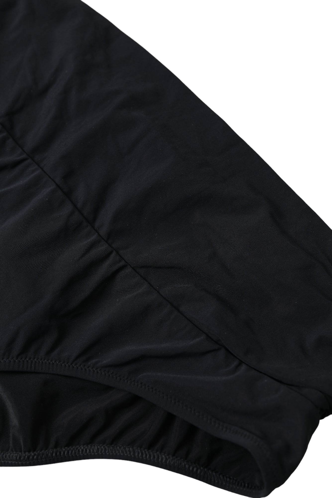 Black nylon stretch swimwear slip bottom bikini by Dolce & Gabbana, featuring smooth fabric and a sleek, fitted design.