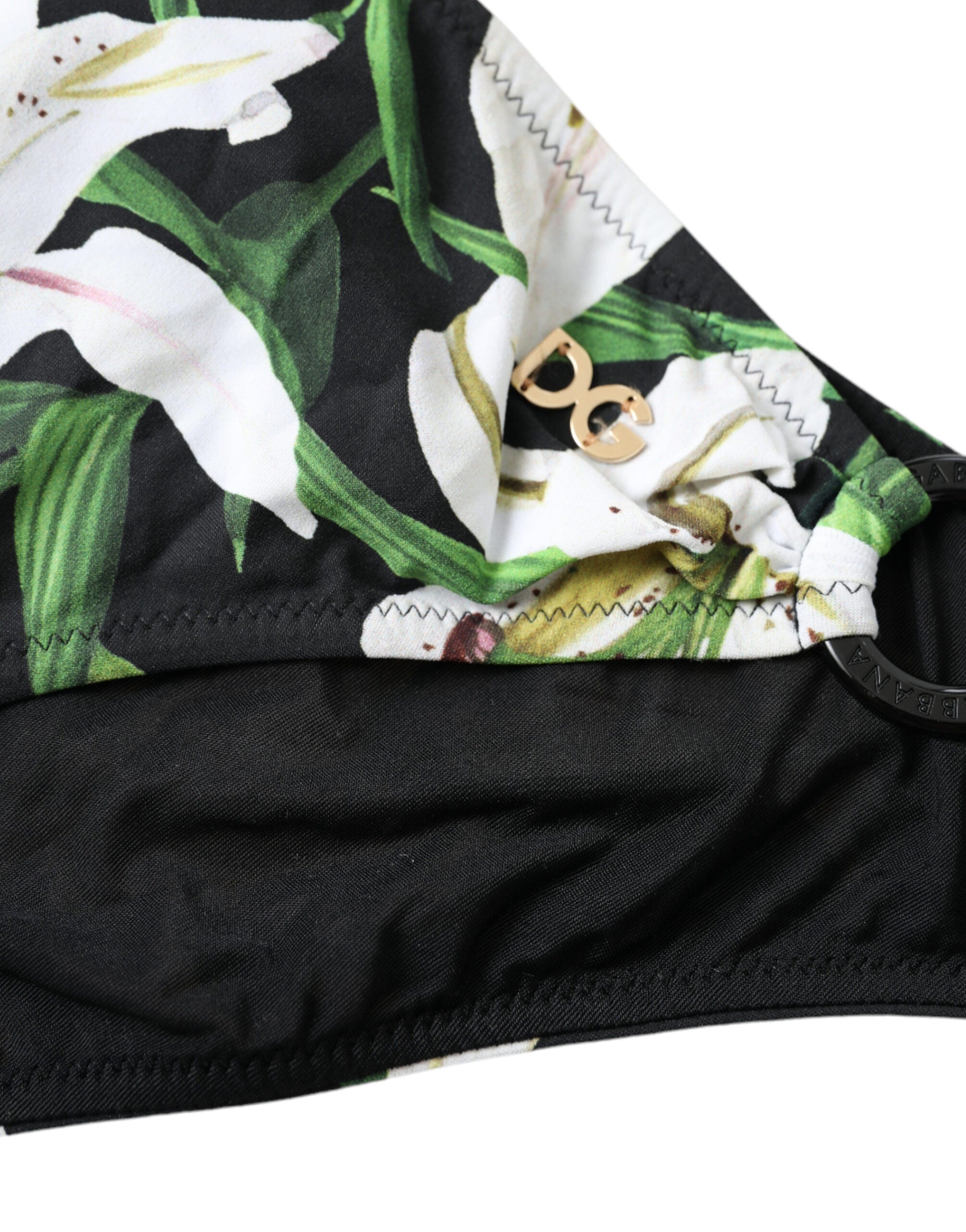 Dolce & Gabbana black lily print swimwear bottom, stylish beachwear bikini bottom with floral design, suitable for swimming and sunbathing.