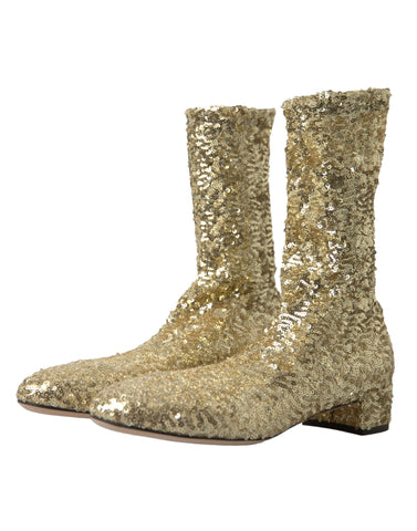 Gold sequined short stretch boots by Dolce & Gabbana with a shiny, shimmering finish and sleek design.