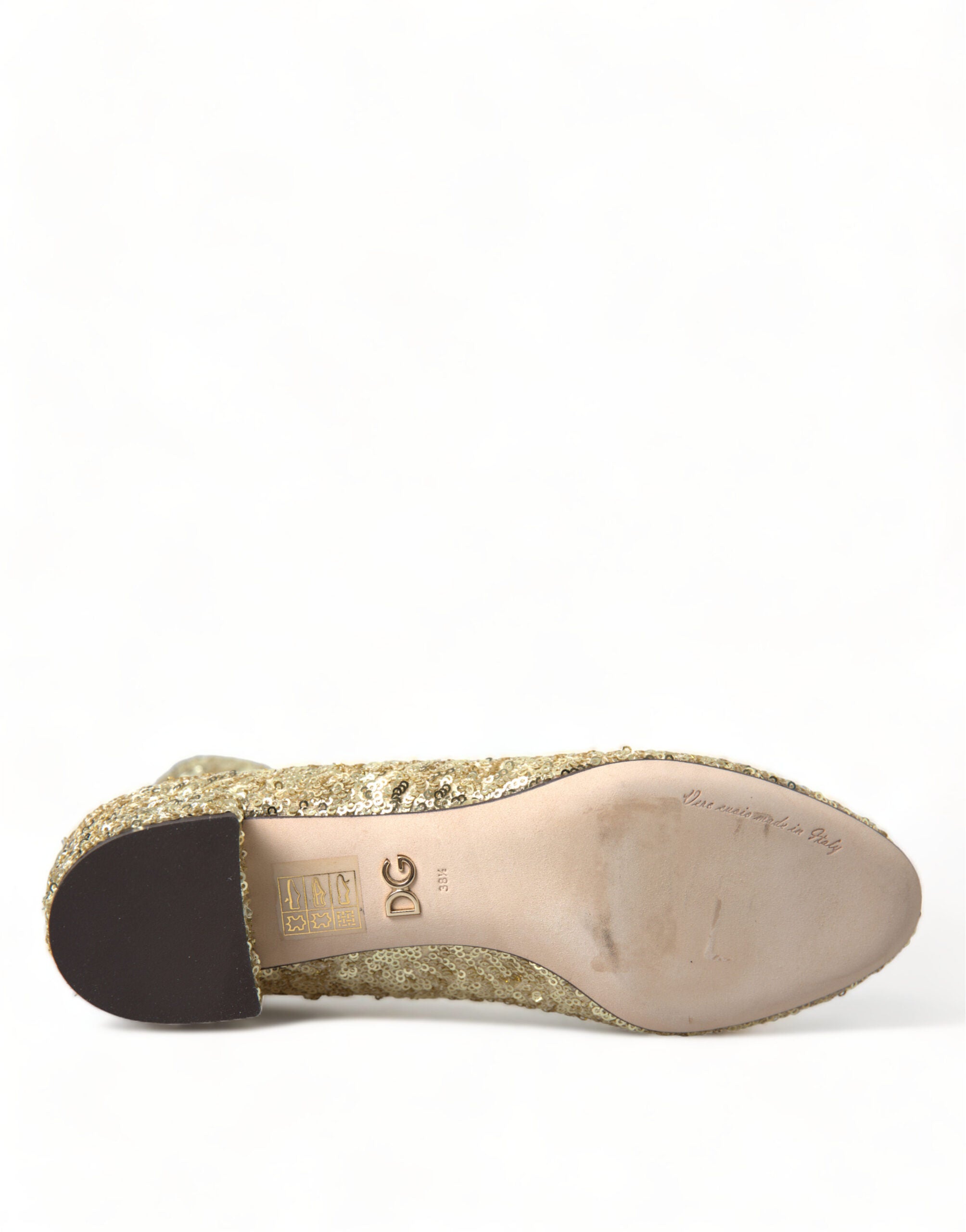 Gold sequined short stretch boots by Dolce & Gabbana shown on a model, featuring a sleek design and shimmering finish.