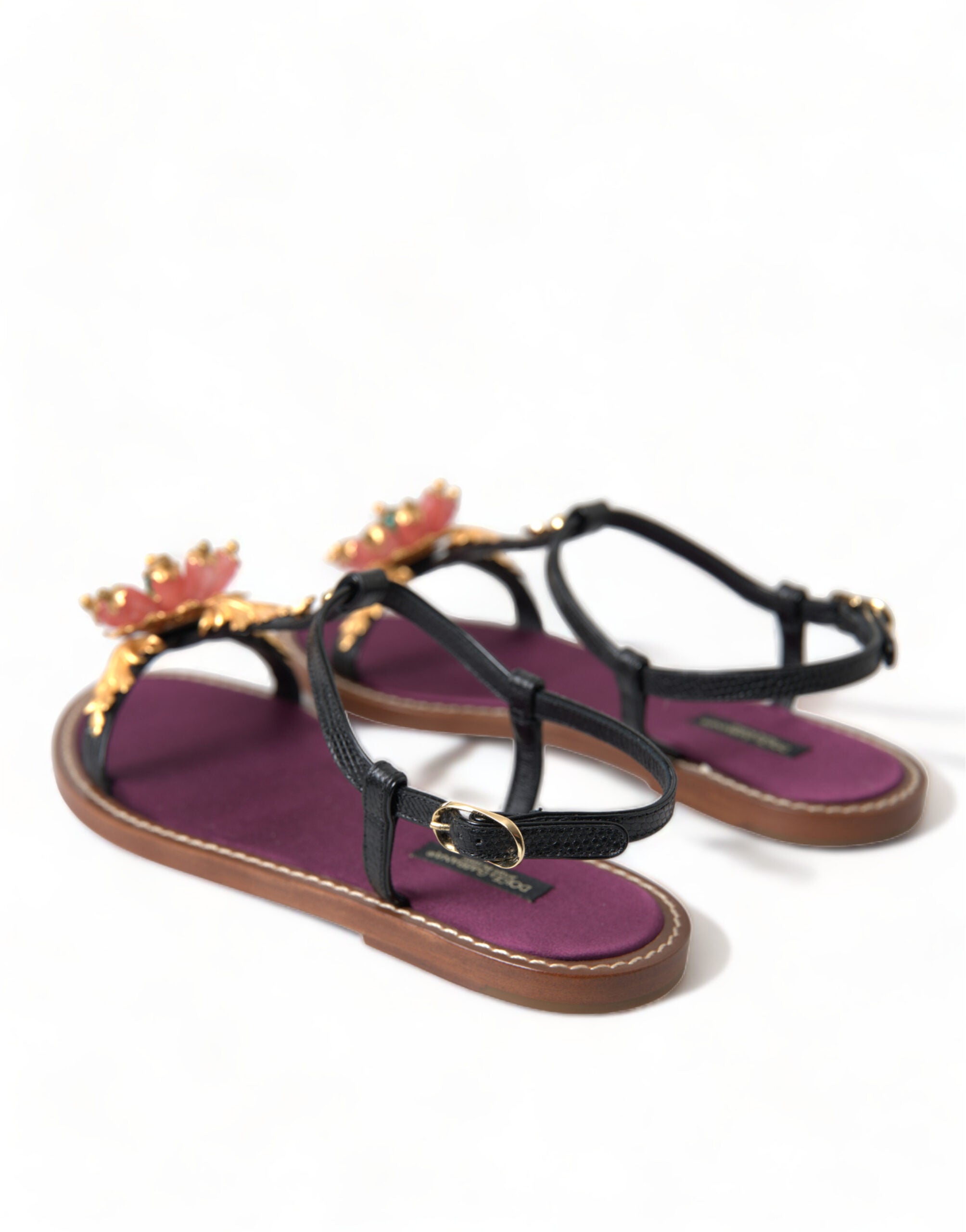 Black crystal and gold leather sandals by Dolce & Gabbana, featuring elegant straps and a luxurious design.