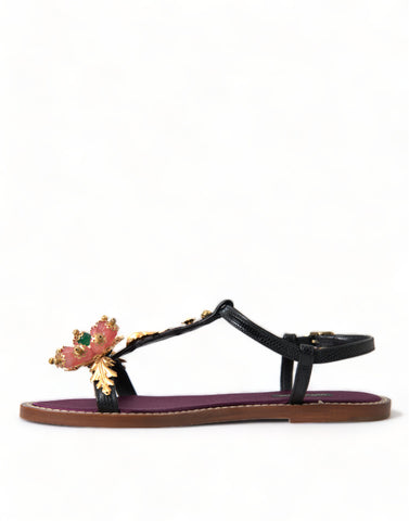 Black crystal and gold leather sandals by Dolce & Gabbana featuring elegant straps and a stylish design.