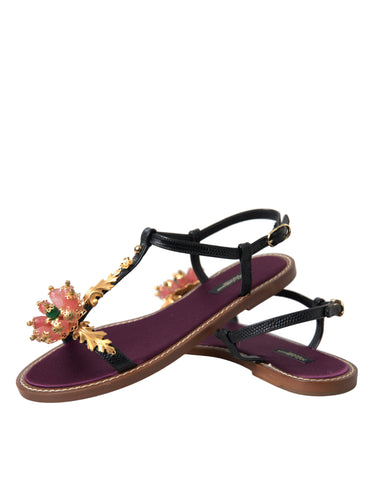 Black crystal and gold leather sandals by Dolce & Gabbana featuring elegant straps and a stylish design.