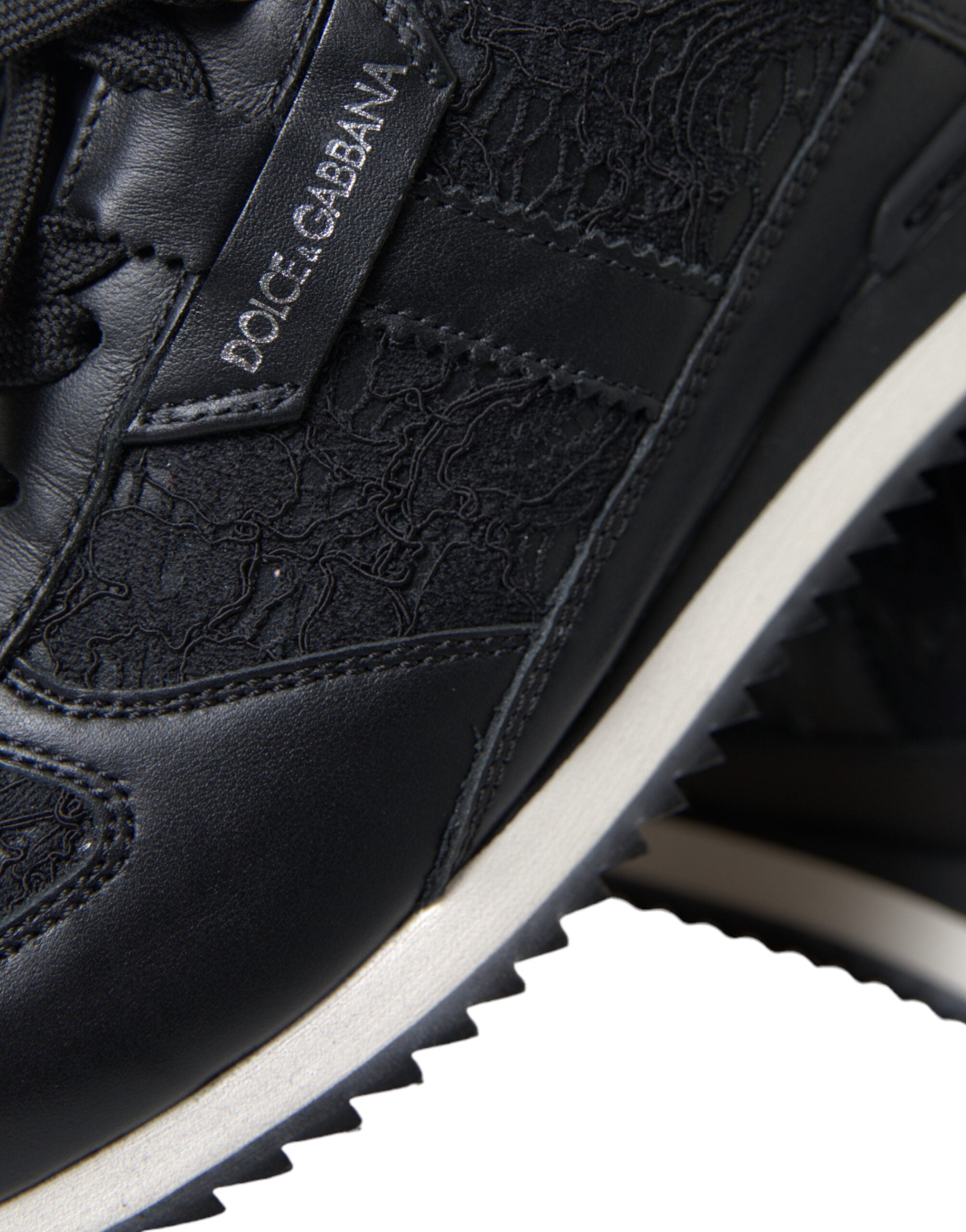 Black floral lace leather sneakers from Dolce & Gabbana with intricate lace detailing and stylish athletic design