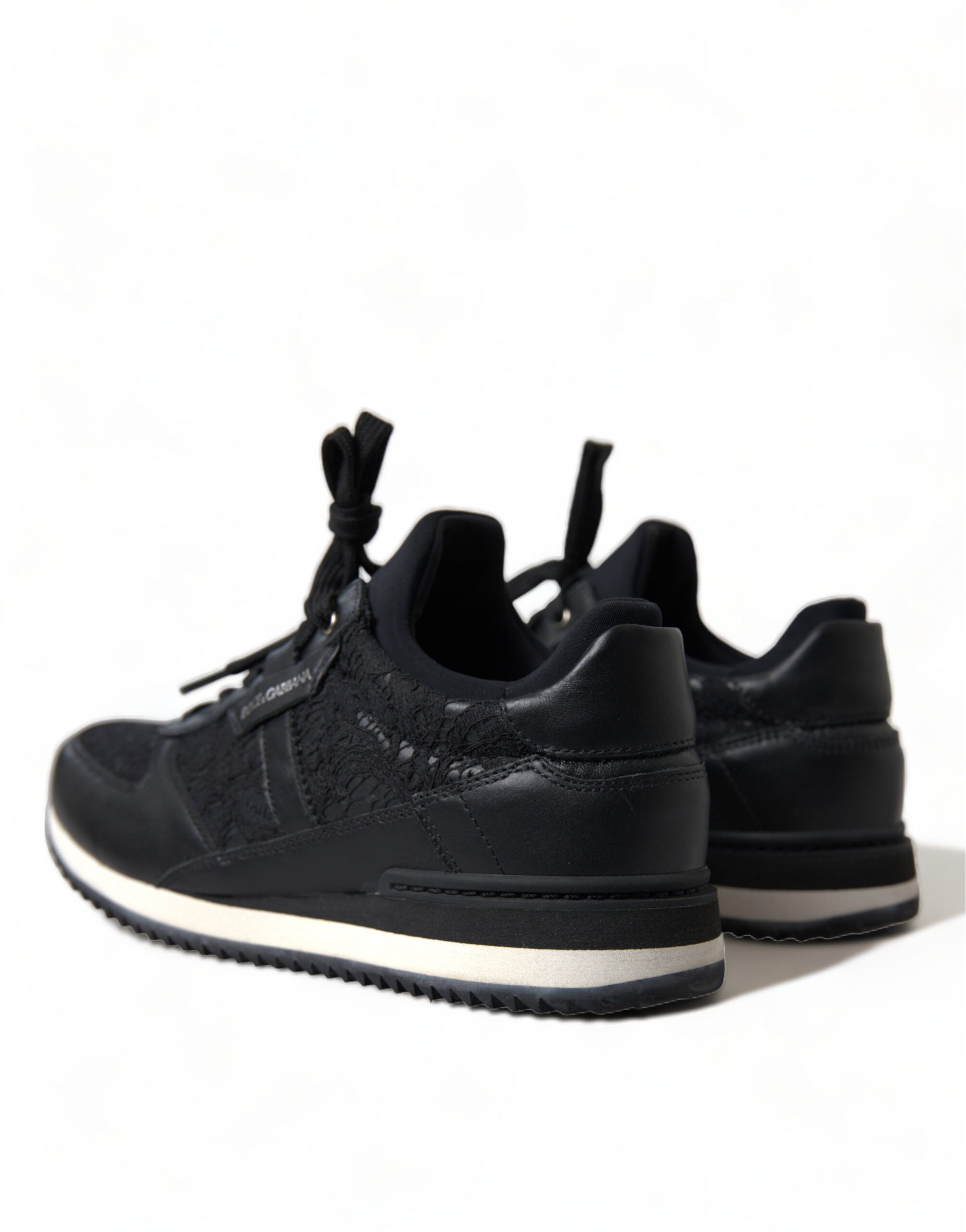 Black floral lace leather sneakers by Dolce & Gabbana with intricate lace detailing and sleek sneaker design.