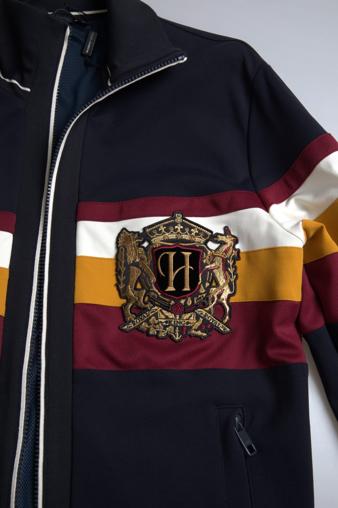 Blue heraldic full-zip cardigan sweater by Dolce & Gabbana with intricate crest embroidery and ribbed cuffs.