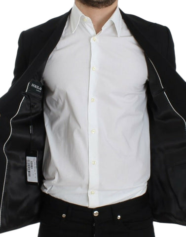 Black wool slim fit blazer by Dolce & Gabbana, tailored with a sleek lapel and modern silhouette, displayed on a hanger.