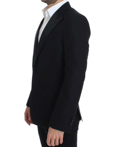 Black wool silk Sicilia blazer by Dolce & Gabbana displayed on a hanger, highlighting tailored fit and luxurious fabric details.
