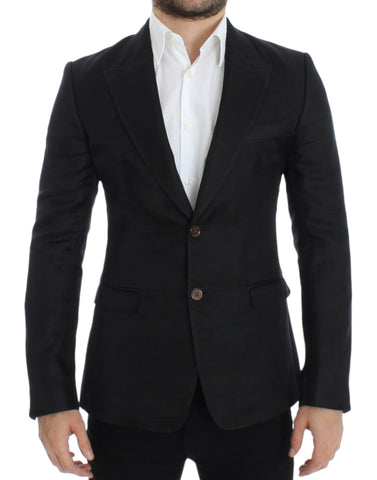 Black silk slim fit blazer by Dolce & Gabbana, tailored with a sleek design and classic lapel, shown on a hanger.