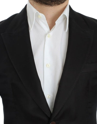 Black silk slim fit blazer by Dolce & Gabbana, tailored with a sleek design and classic lapel, displayed on a hanger.
