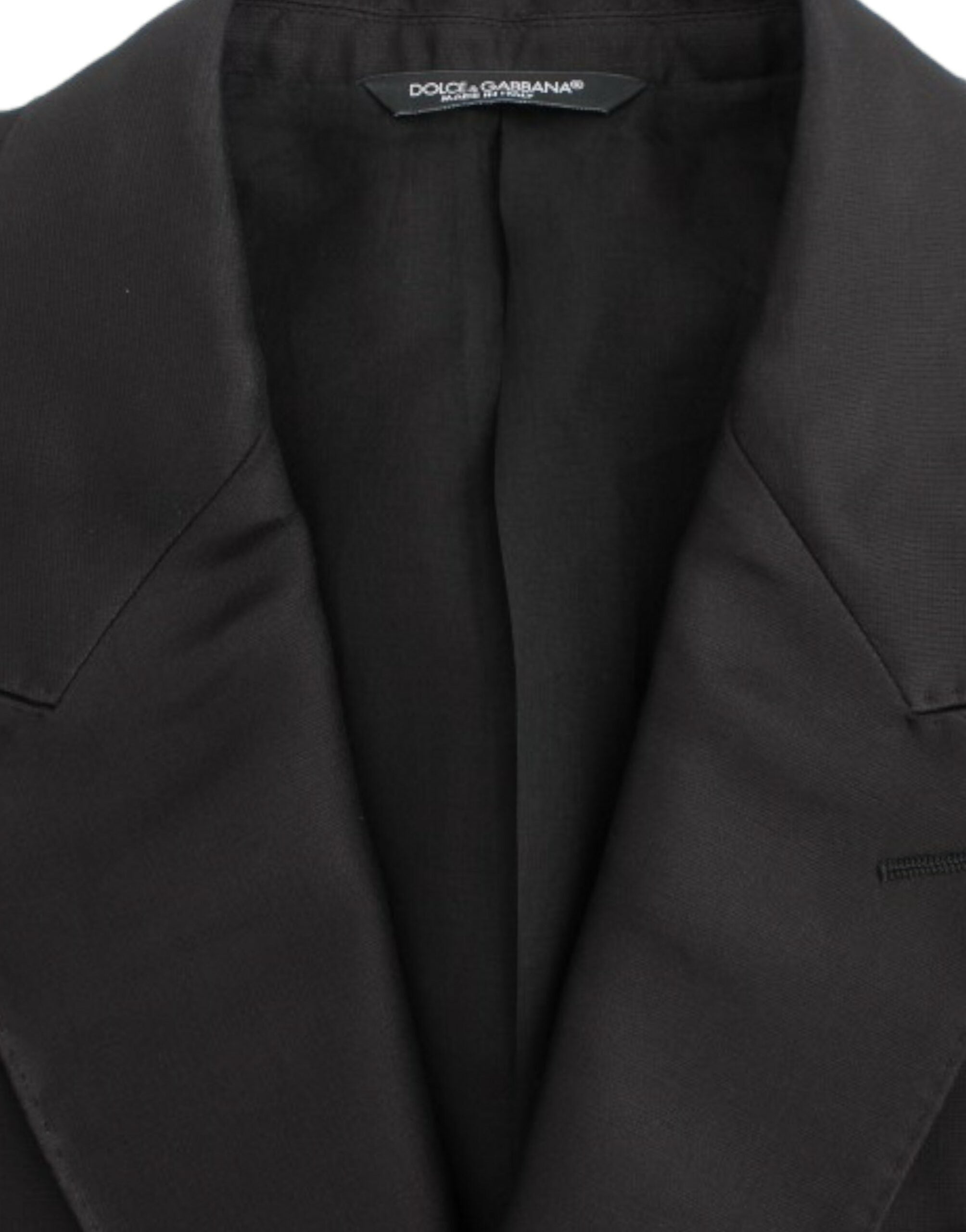 Black silk slim fit blazer by Dolce & Gabbana, tailored with a sleek fit and smooth fabric, shown on a hanger.