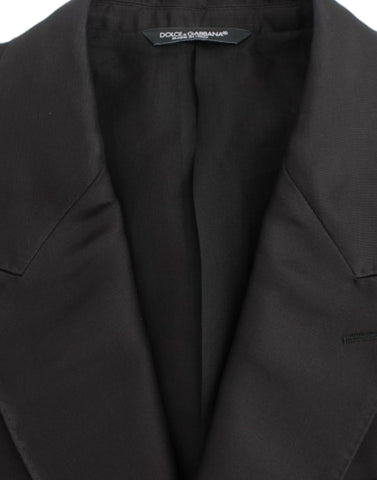 Black silk slim fit blazer by Dolce & Gabbana, tailored with a sleek fit and smooth fabric, shown on a hanger.