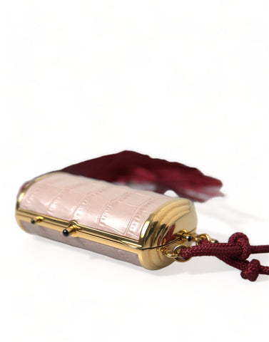 Pink exotic leather mini makeup bag with tassel detail from Dolce & Gabbana, featuring a compact design and luxurious texture.