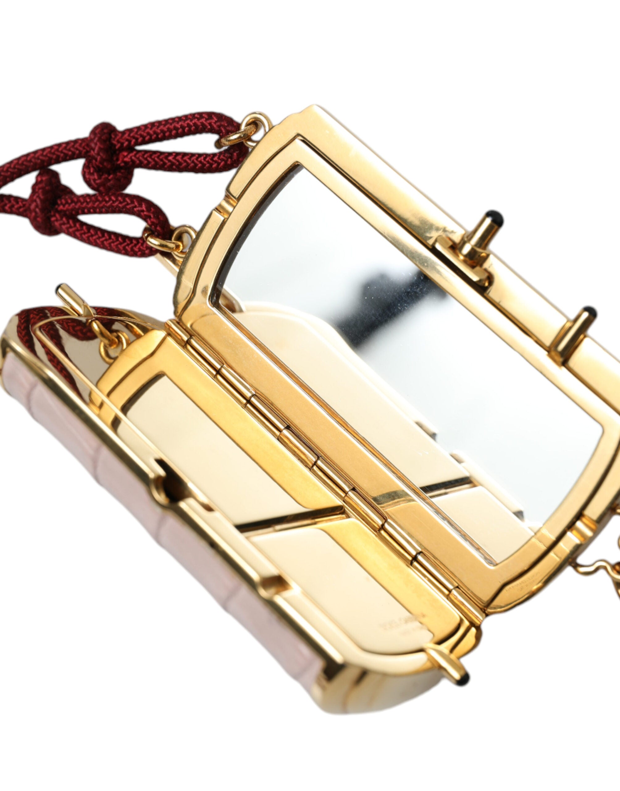 Pink exotic leather mini makeup bag with tassel from Dolce & Gabbana featuring a compact mirror interior.