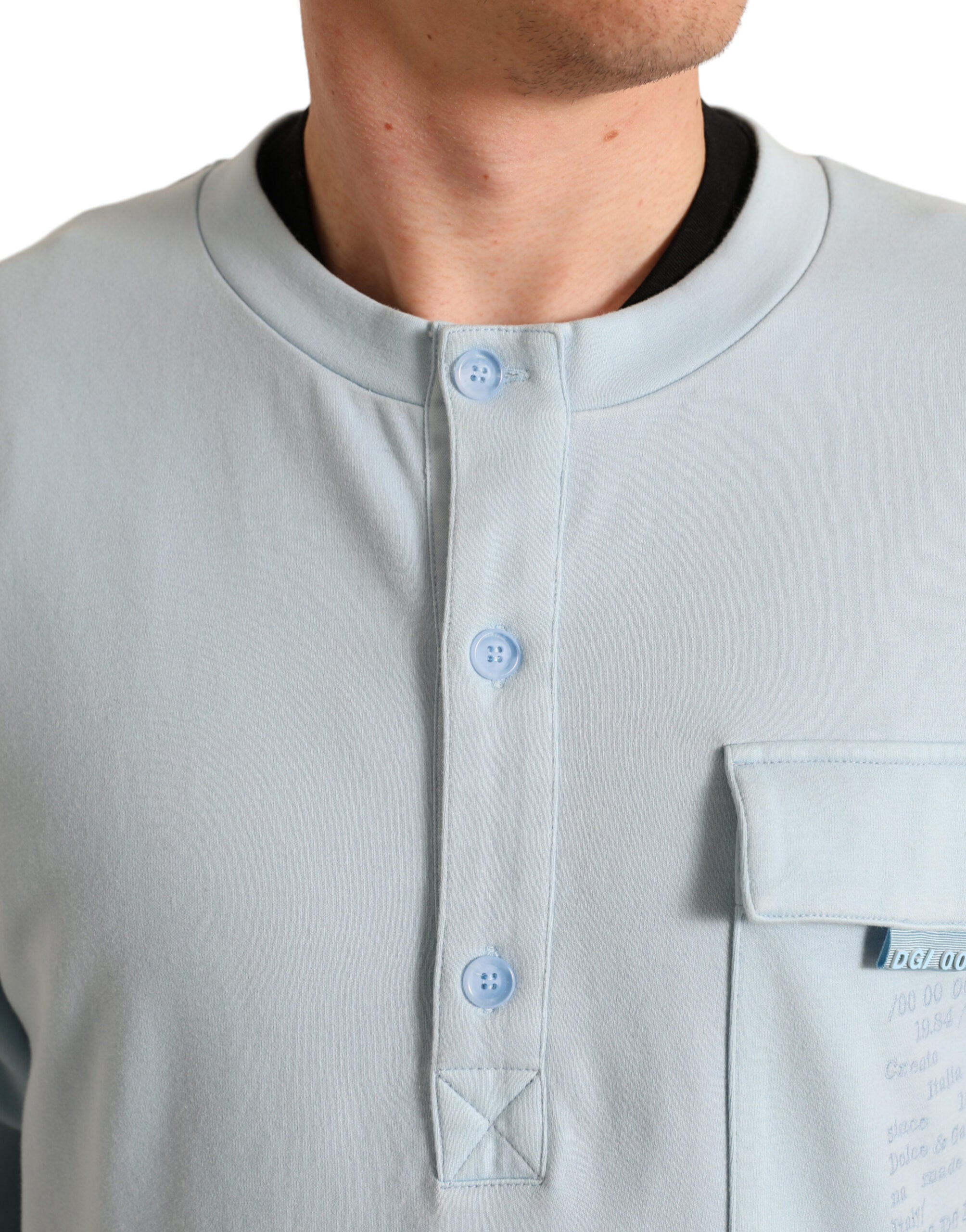 Light blue cotton buttoned pullover sweater by Dolce & Gabbana, featuring a classic knit design and button-up front.