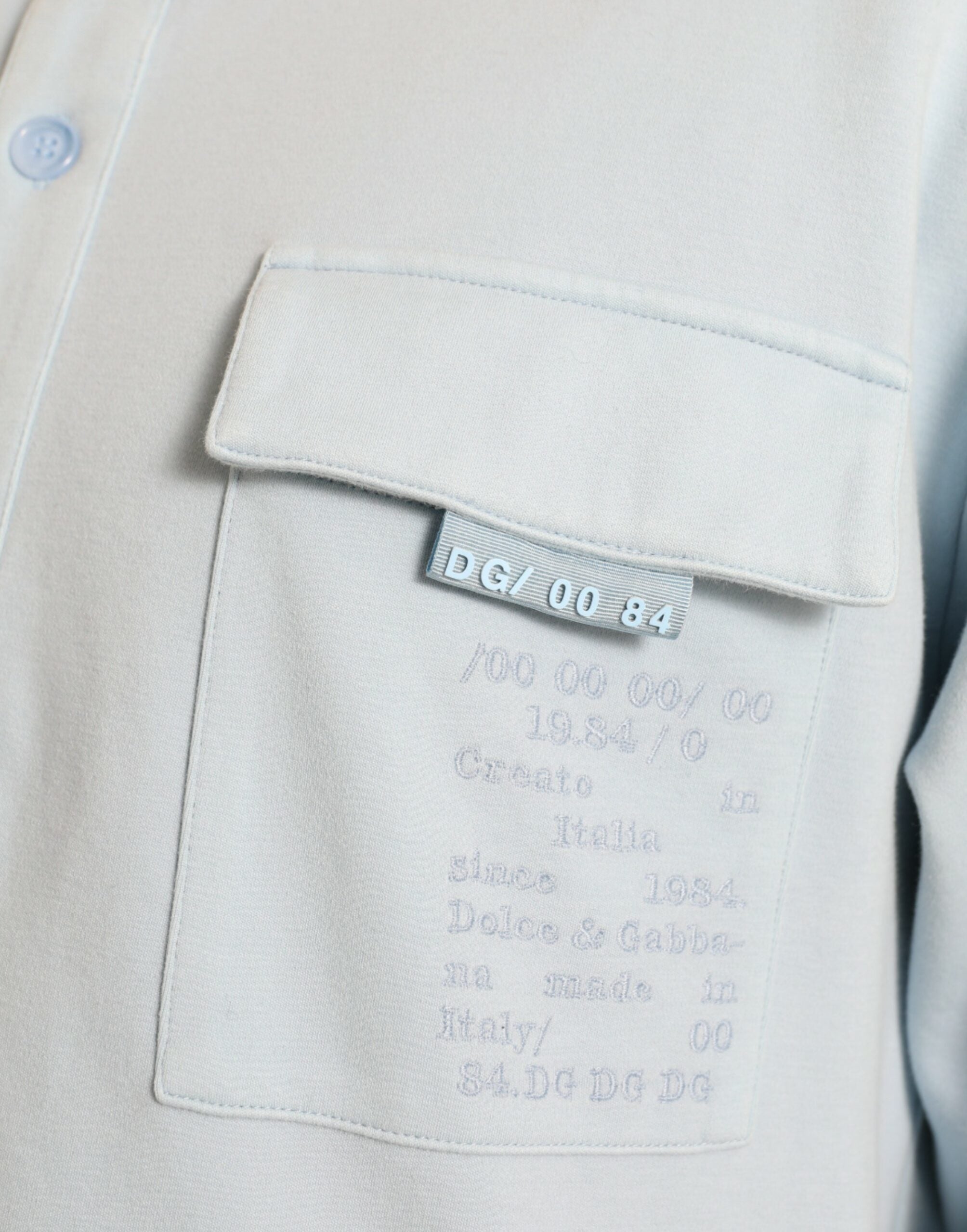 Light blue cotton buttoned pullover sweater by Dolce & Gabbana, featuring a classic crew neck and textured knit fabric.