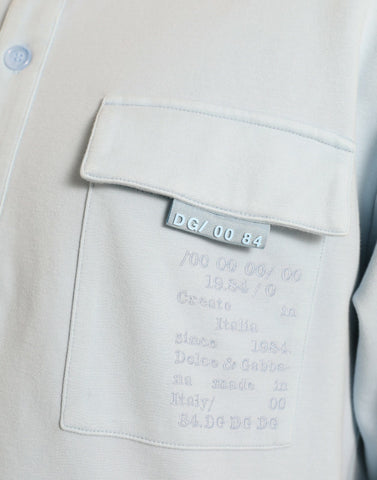 Light blue cotton buttoned pullover sweater by Dolce & Gabbana, featuring a classic crew neck and textured knit fabric.