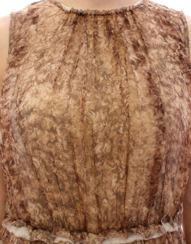 Brown sleeveless silk dress by Dolce & Gabbana displayed on a hanger against a neutral background.