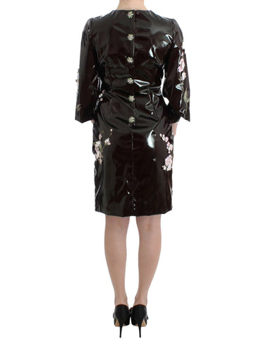 Black patent floral handpainted dress by Dolce & Gabbana, showcasing intricate floral patterns and glossy finish.