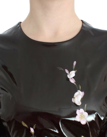 Black patent floral handpainted dress by Dolce & Gabbana, featuring intricate floral designs and a sleek, shiny finish.