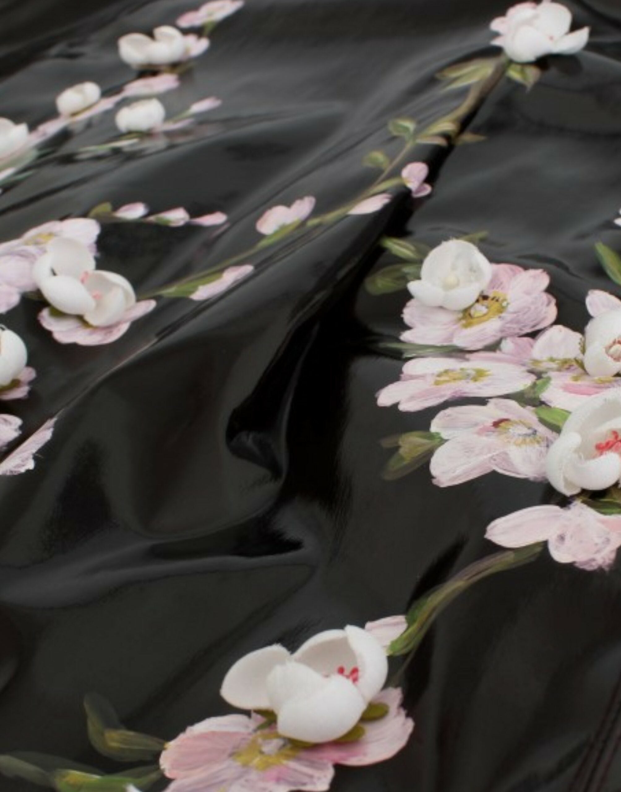 Black patent floral handpainted dress by Dolce & Gabbana, showcasing intricate floral patterns and sleek patent fabric.