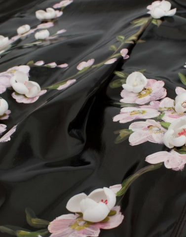 Black patent floral handpainted dress by Dolce & Gabbana, showcasing intricate floral patterns and sleek patent fabric.