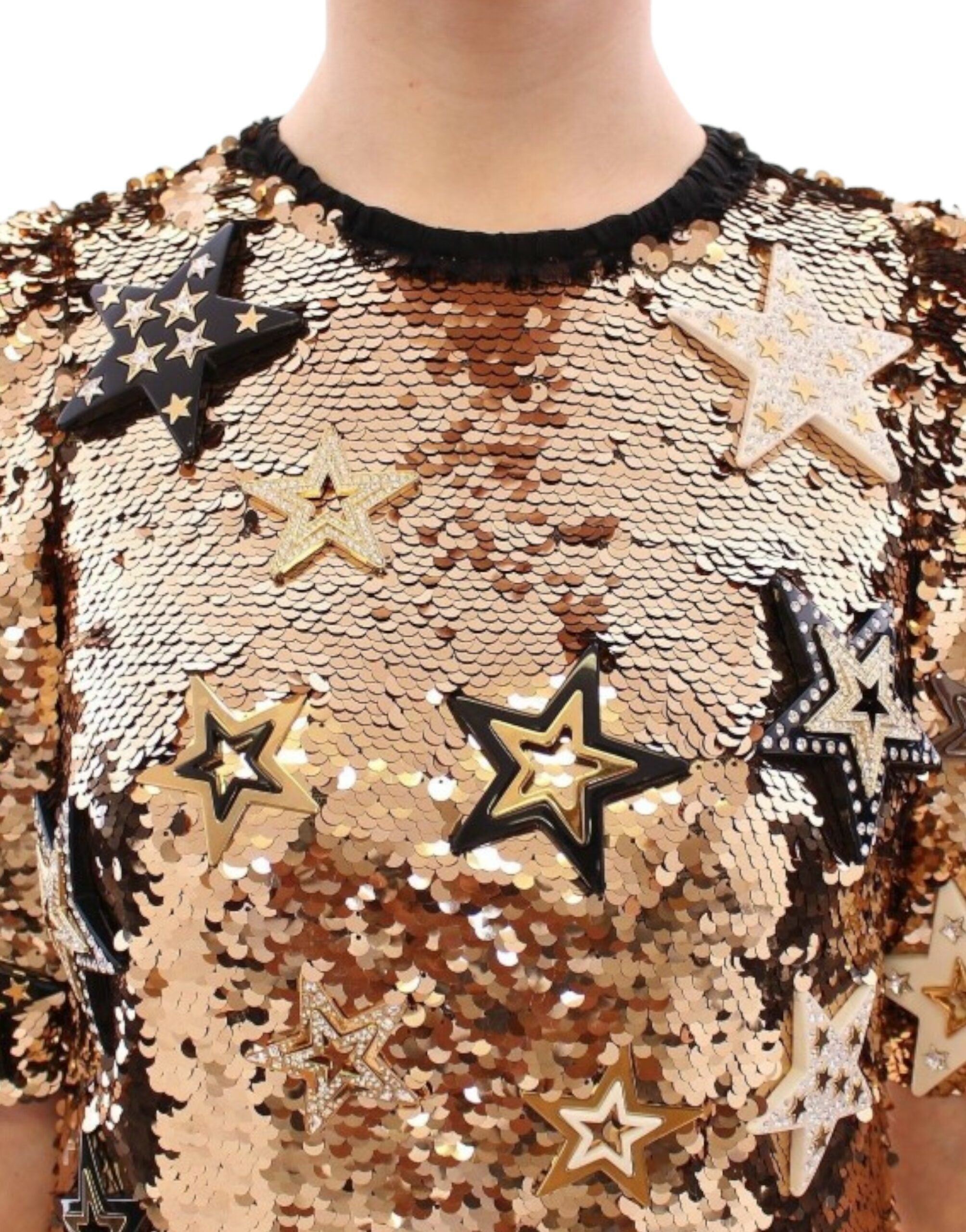 Gold sequined Swarovski dress by Dolce & Gabbana with intricate crystal embellishments and a fitted silhouette.