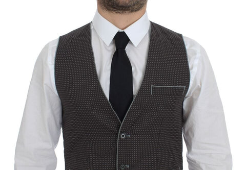 Gray polka dot dress vest by Dolce & Gabbana, stylish gilet with button details and classic pattern, displayed on a hanger.