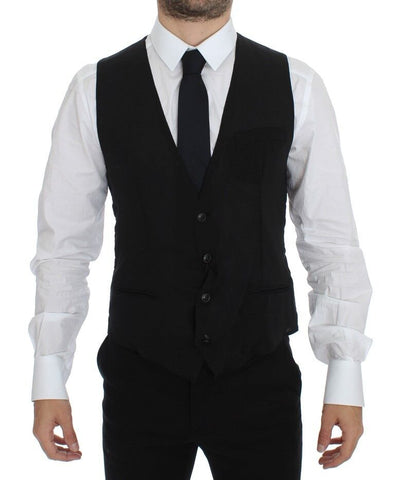 Black wool formal dress vest gilet jacket by Dolce & Gabbana, tailored fit with sleek lapel and button closure, displayed on a hanger.