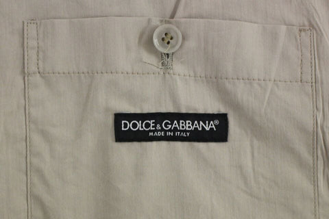 Beige cotton slim fit button-front dress vest by Dolce & Gabbana, tailored with a sleek, fitted design and front buttons.